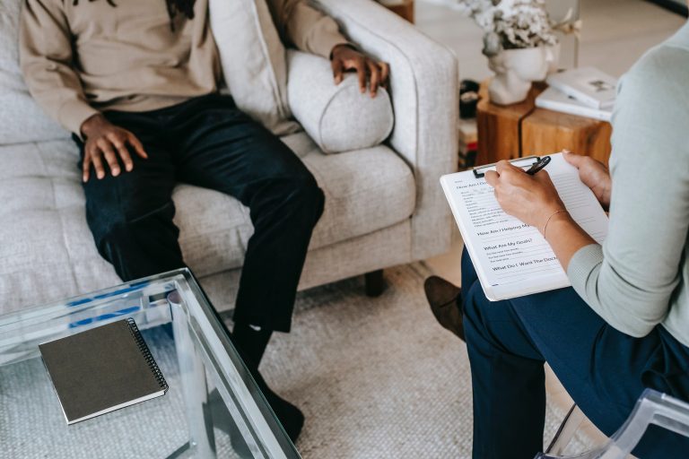 A man sits on a sofa as a therapist across from them writes on their clipboard. This could represent individual therapy in Pasadena, CA. Contact an individual therapist to learn more about individual therapy for relationship issues in Sacramento, CA and other services. 95630 | 95687 | 95747