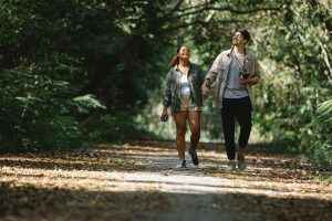 A couple hikes on a trail enjoying the peace of nature and reconnecting with each other. Learn more in Couples Therapy in Pasadena. CA.