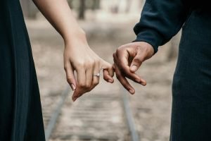 A couple tentatively holds hands representing the rebuilding of trust after betrayal. Couples Therapy in Pasadena, CA can help.